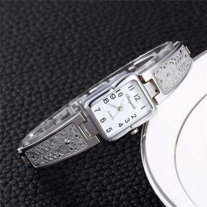 Montre Femme Quartz TINUORA TMC383 — Boîtier Rectangulaire Acier Inox, Chiffres Arabes, Style Luxe